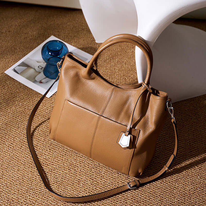 Woman holding an elegant brown leather handbag