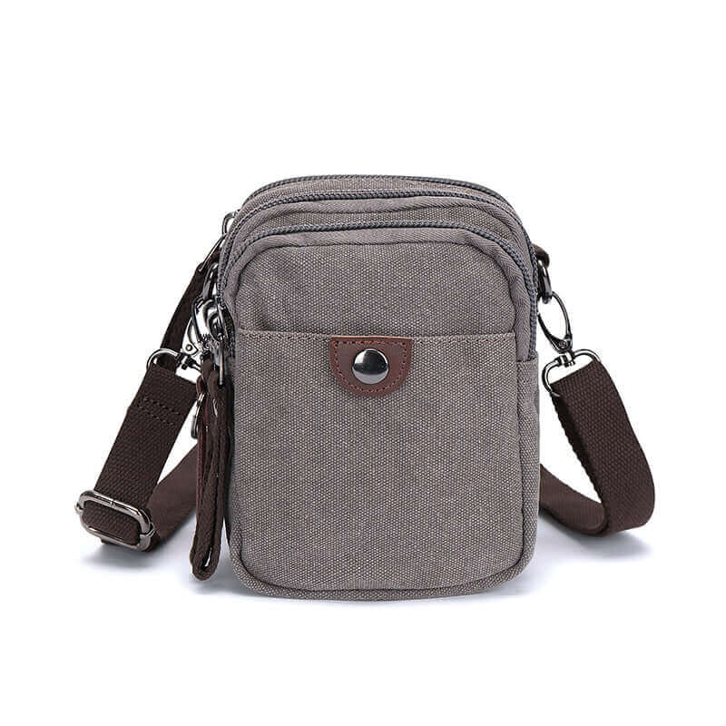 Close-up front view of the grey canvas small crossbody bag.