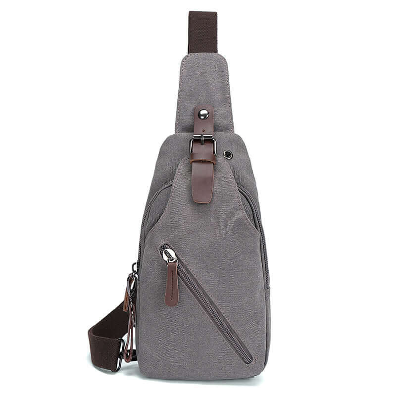 Gray canvas sling bag, offering ample storage and versatility, ideal for travel and outdoor adventures.