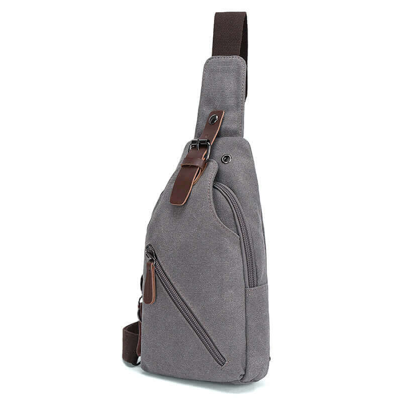 Side view of the grey canvas crossbody sling bag.