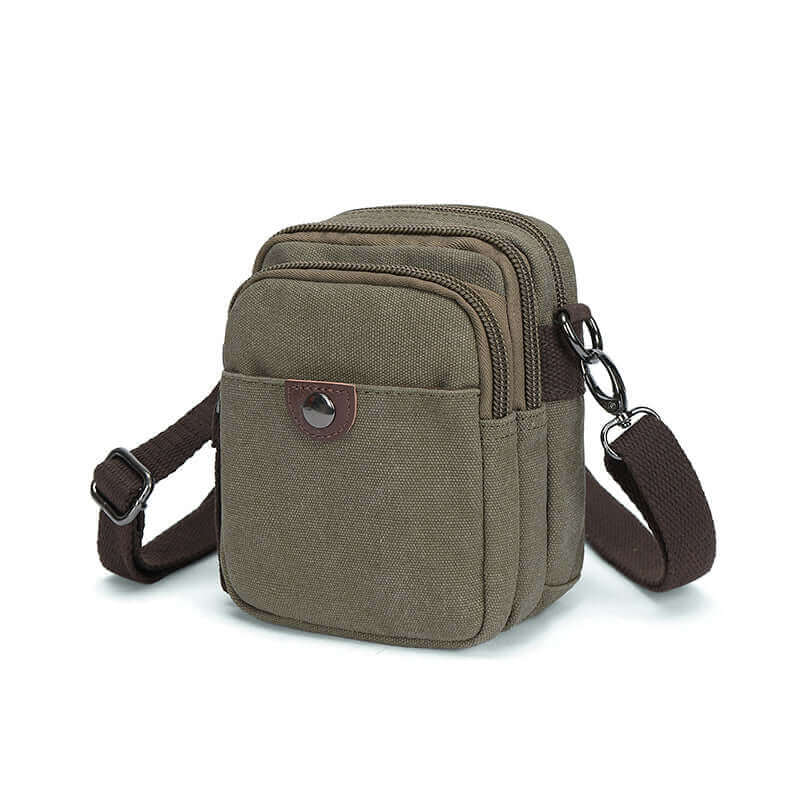 Side view of the green canvas small crossbody bag showing its compartments.