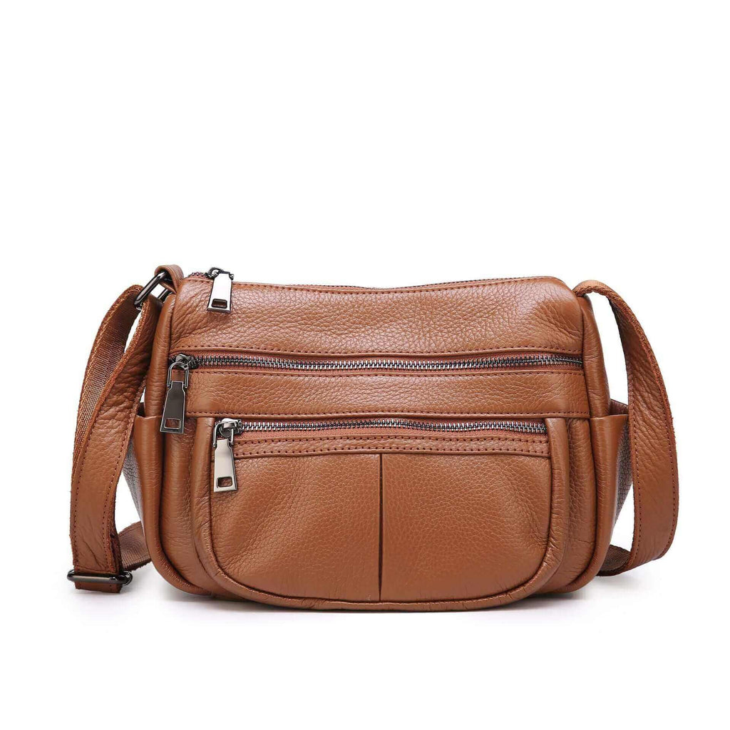 Minimalist leather crossbody bag featuring zippered pockets and durable craftsmanship.