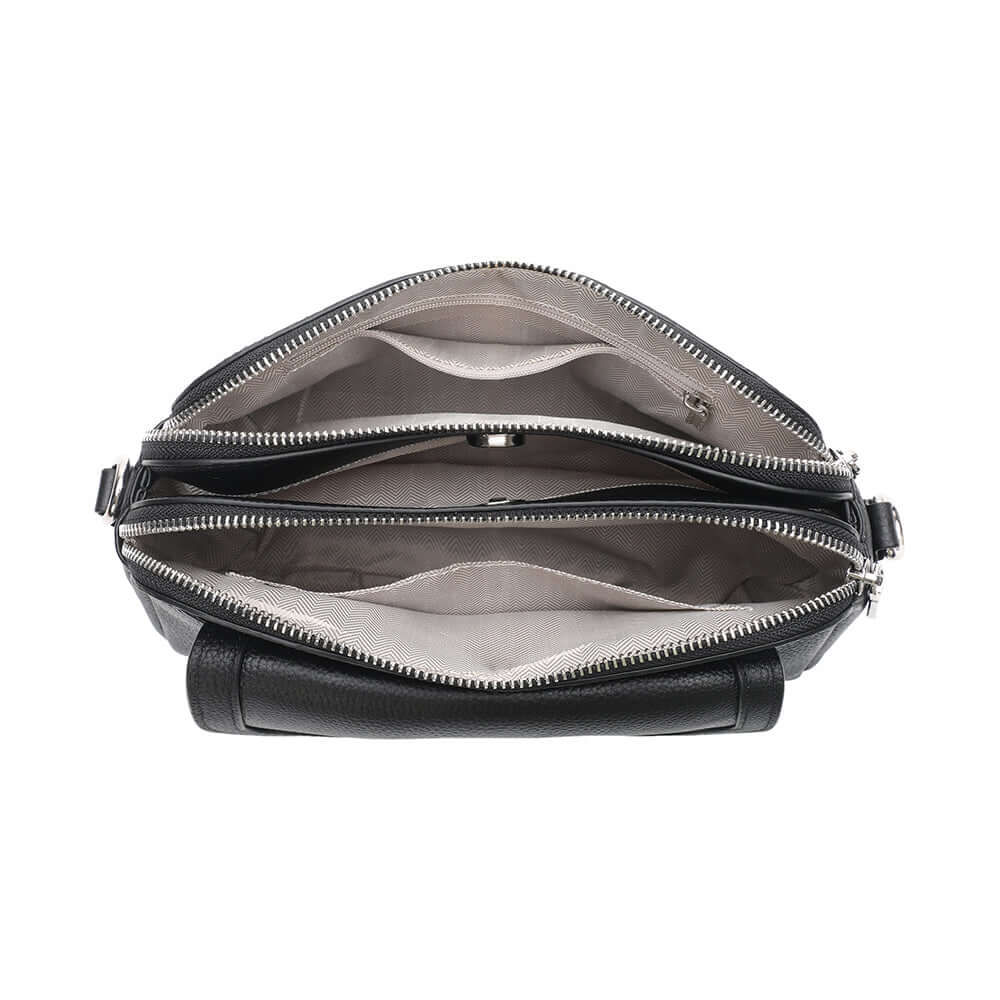 Interior layout of black leather crossbody with multiple compartments.