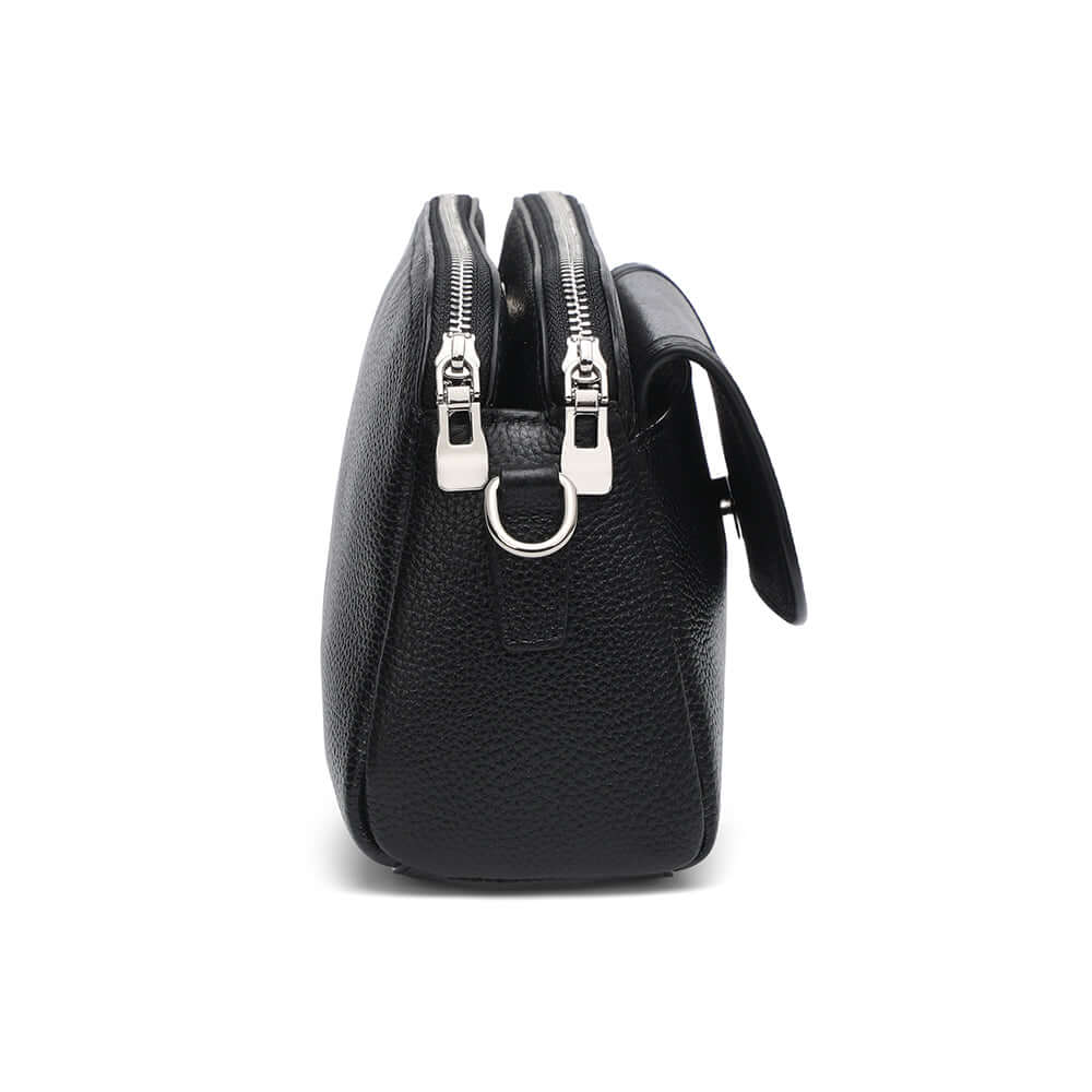 Side profile of black leather crossbody showing double zippers.