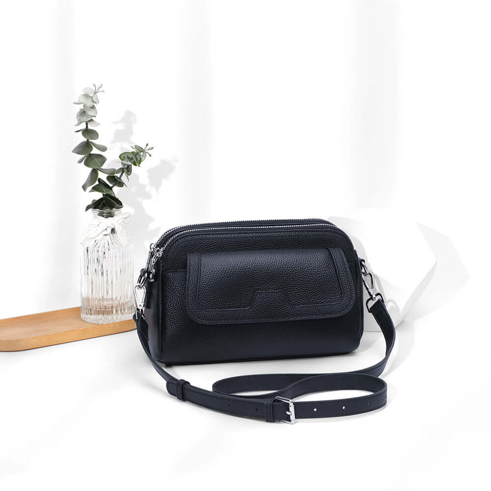 Black leather women’s crossbody with adjustable long strap.