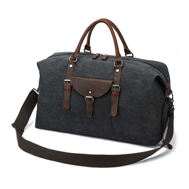 Black duffle bag with brown leather straps