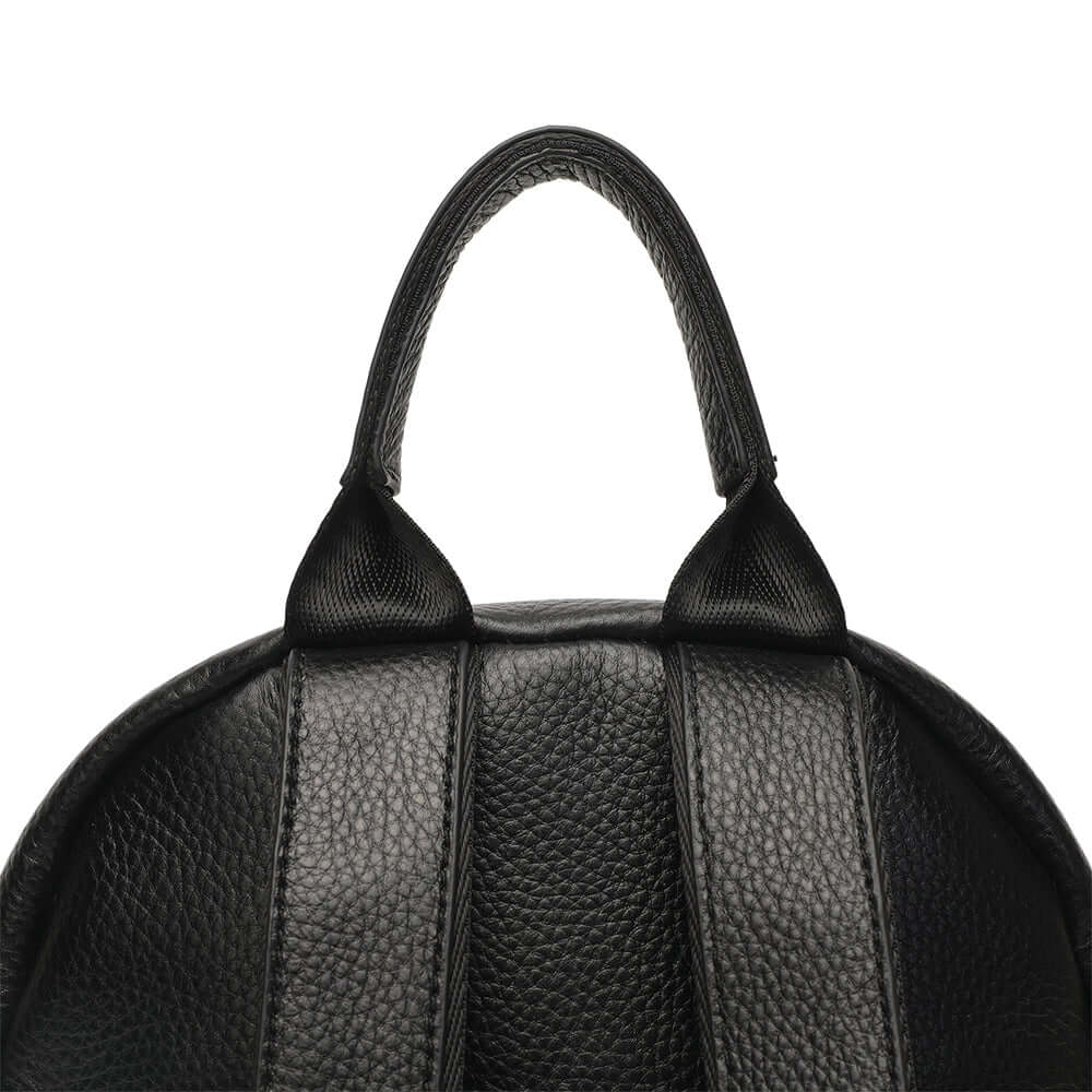 Close-up of a black leather backpack handle