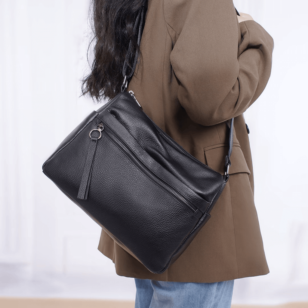 Model carrying shoulder bag on shoulder