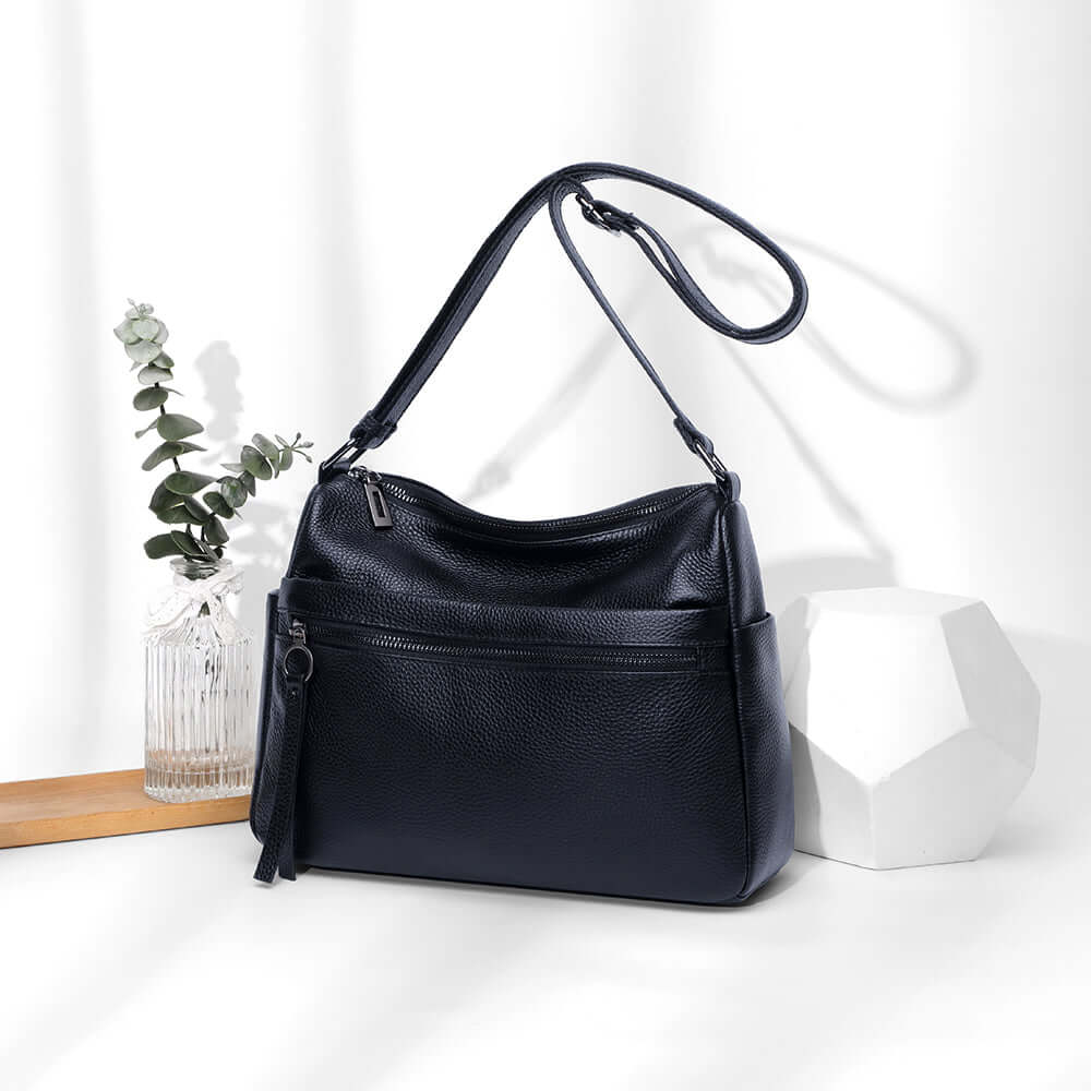 Leather shoulder bag styled on white background