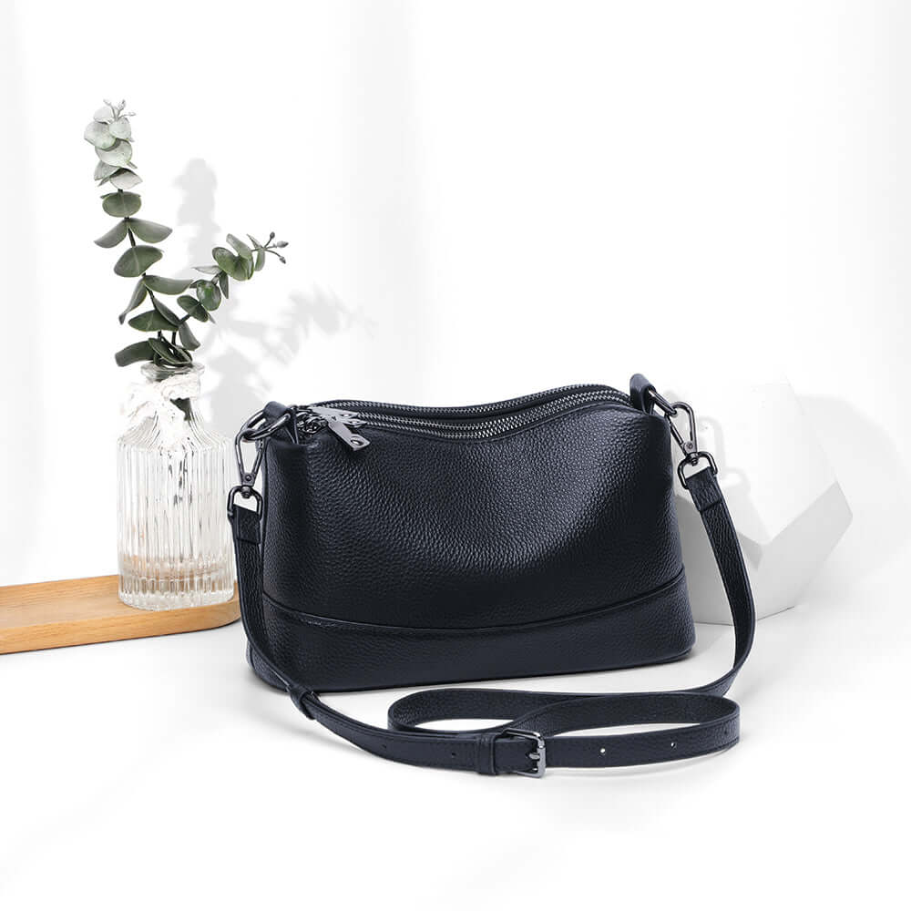 Black leather bag in lifestyle setting.