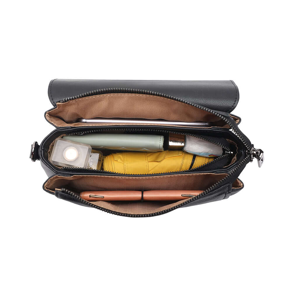 Inside compartments of leather flap bag with organised pockets