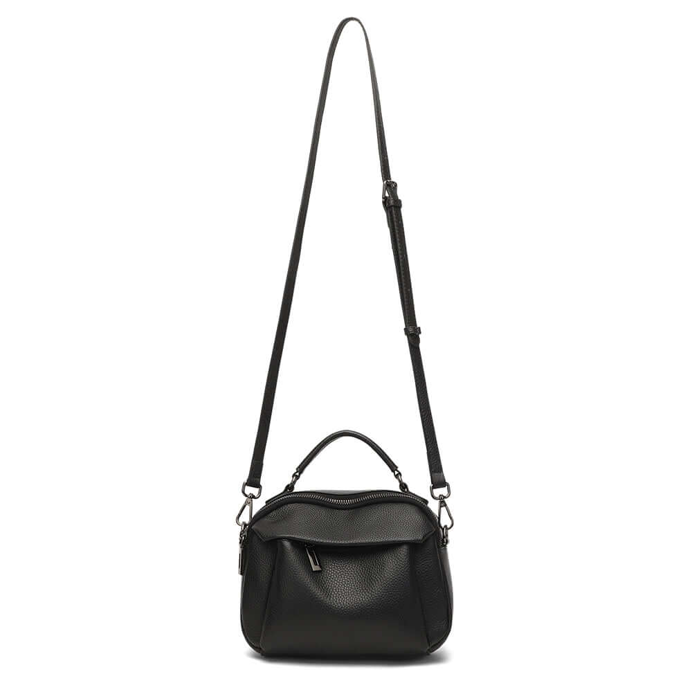 Black leather handbag shown with long crossbody strap