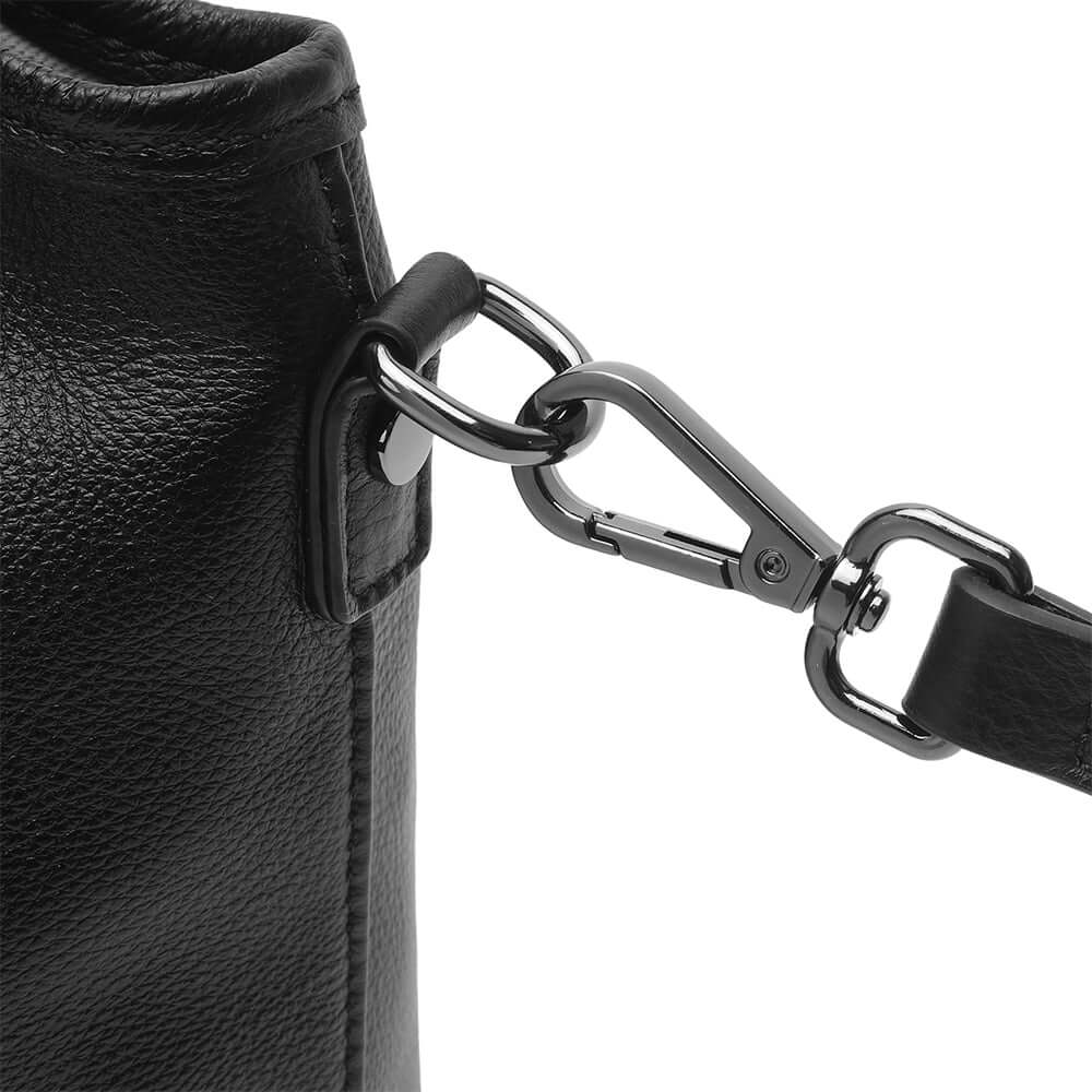 Close-up of a black leather bag with a metal chain strap