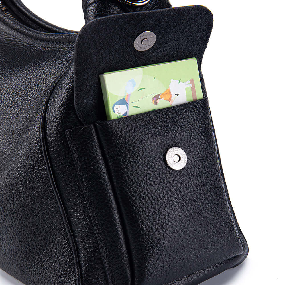 Black handbag with a card holder attached, featuring a cartoon design.