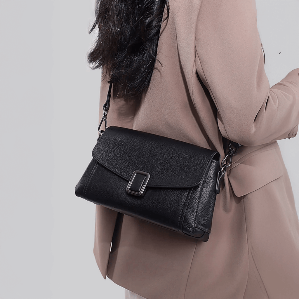 Woman carrying leather flap crossbody bag