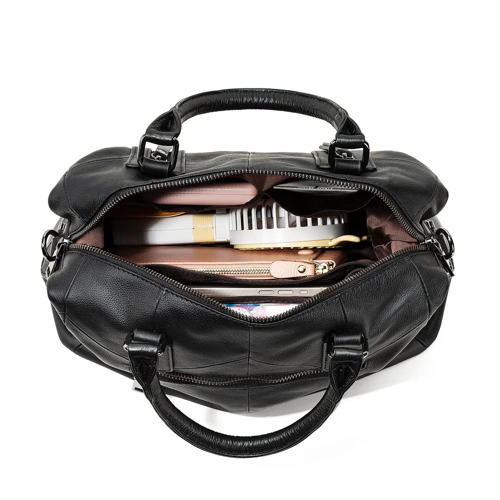 Black leather shoulder bag with items inside