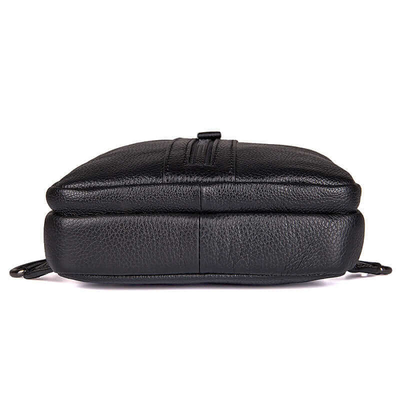 Bottom view of the black leather sling bag.