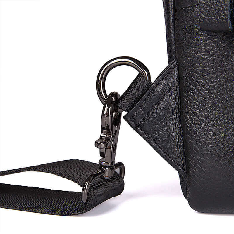Detailed display of the black leather crossbody sling bag.