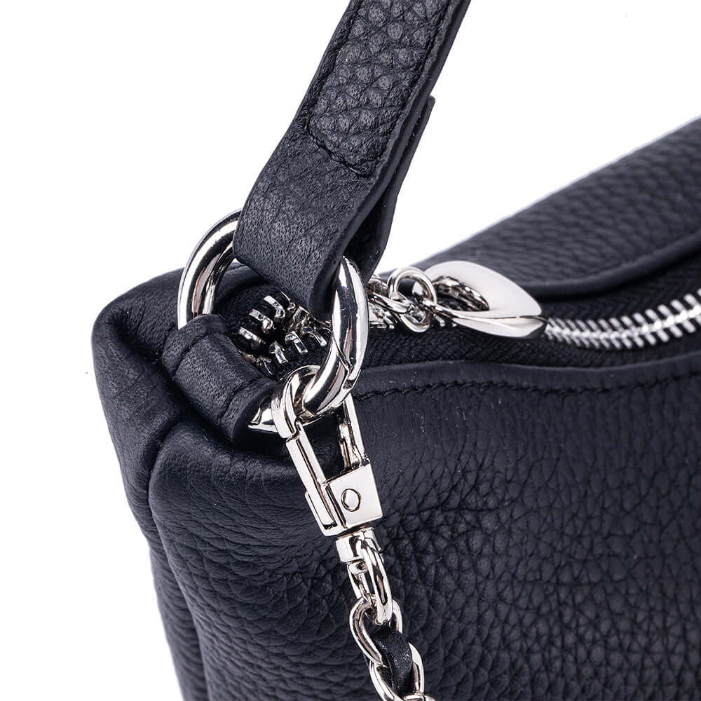 Close-up of a black handbag with a silver chain strap