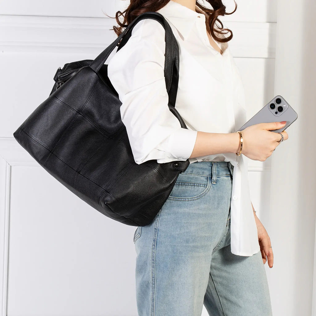 Leather tote worn over shoulder – daily carry option