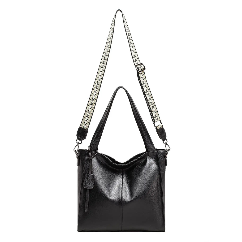 Crossbody style featuring woven strap on black tote bag