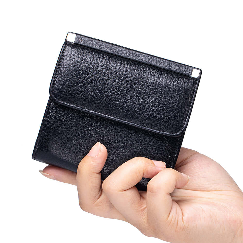 Hand holding a black leather wallet