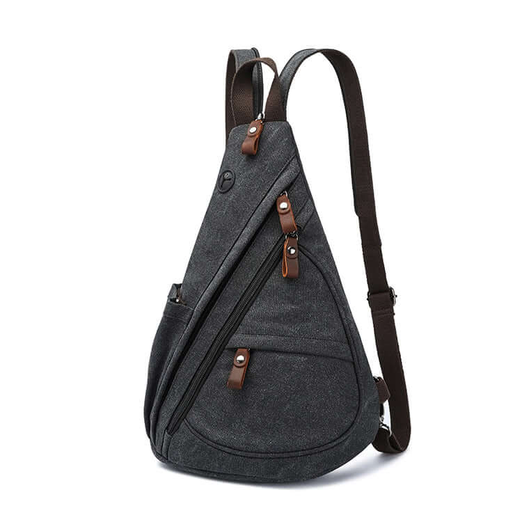 Side angle of black canvas sling bag with leather zip pull