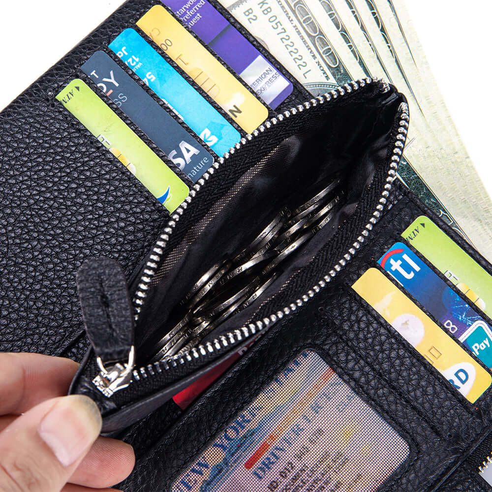 Black wallet with various cards and money held open by a hand
