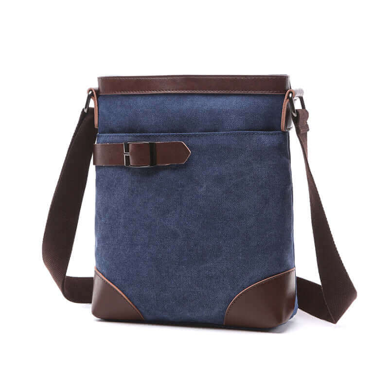 Men's canvas messenger bag with leather and buckle accents.