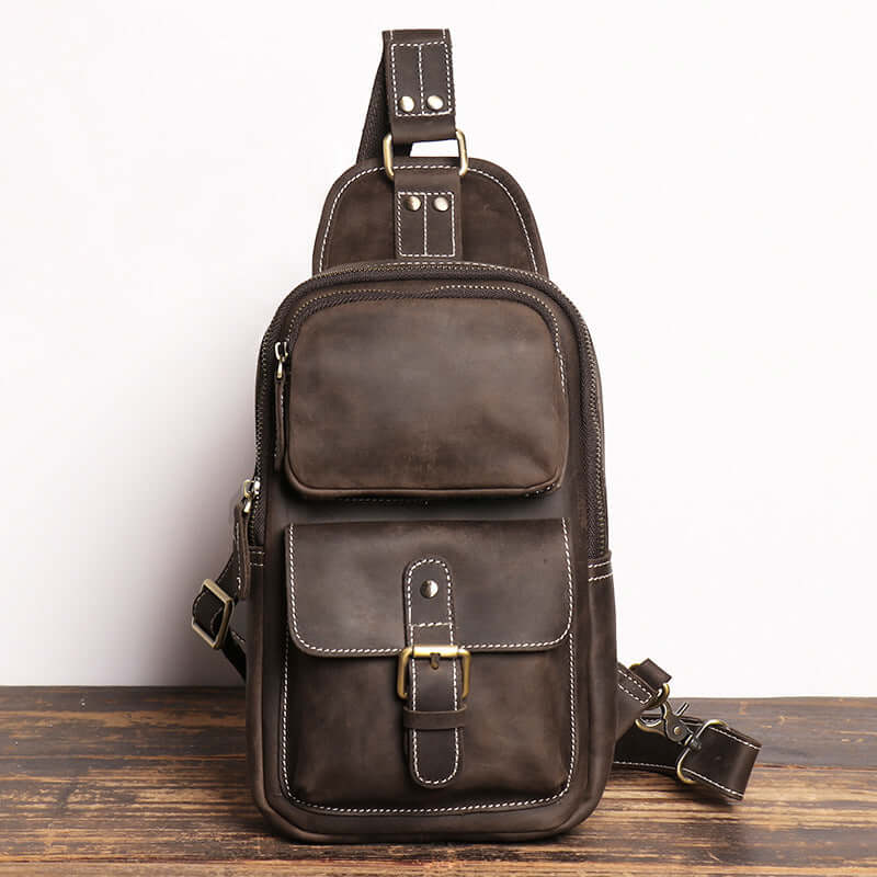 Multi-pocket men’s sling bag in brown genuine leather with vintage finish.