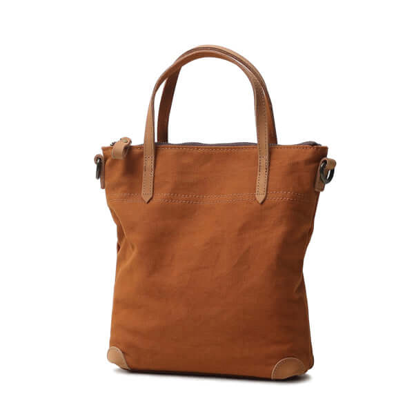 Brown canvas handbag with genuine leather handles.