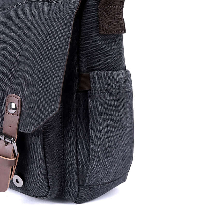 Partial details of the canvas crossbody laptop bag.