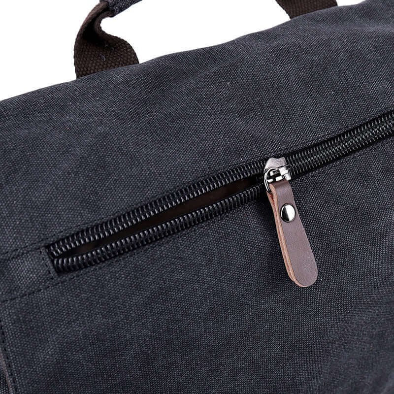 Zipper partial details of the canvas laptop crossbody bag.