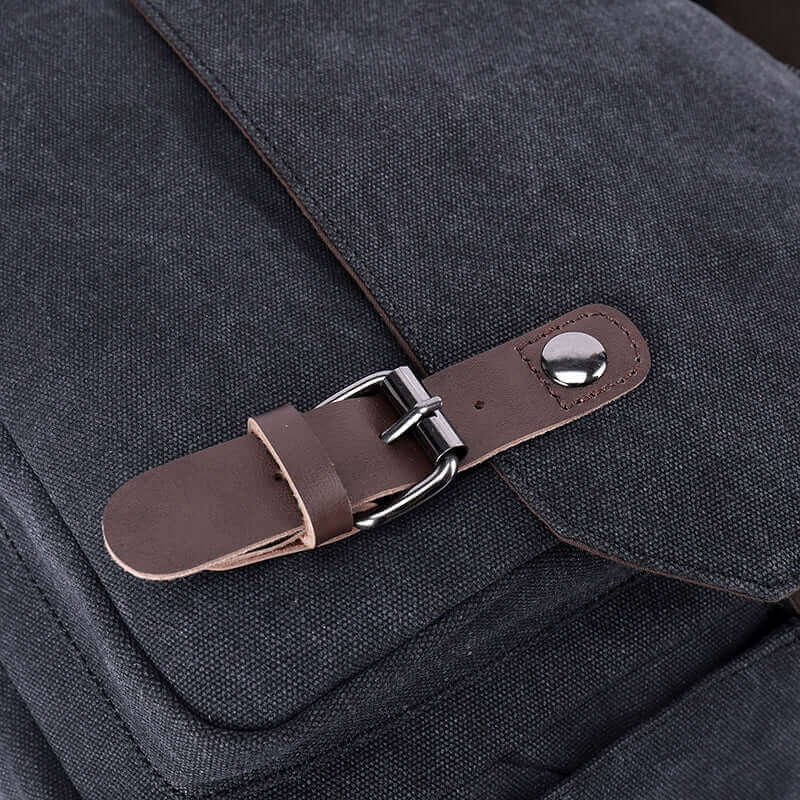 Partial details of the canvas crossbody messenger bag.
