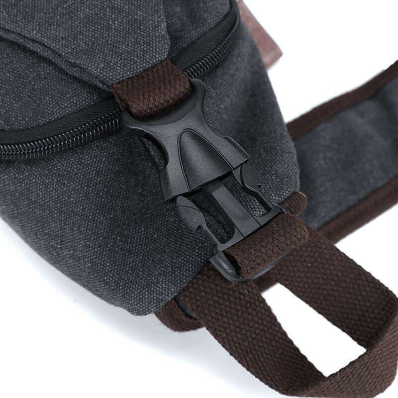 Partial details of the black canvas crossbody sling bag.