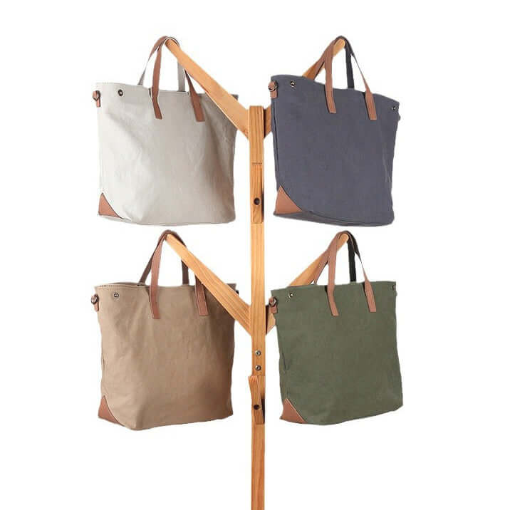 Canvas tote bags in khaki, white, grey, and green.
