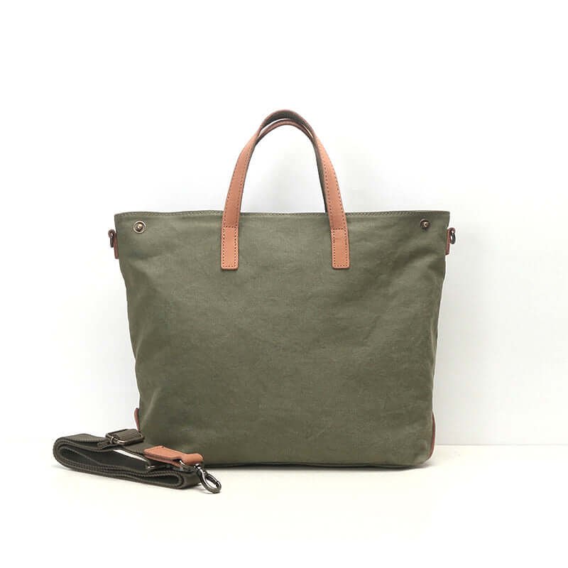 Green canvas tote bag with leather handles.