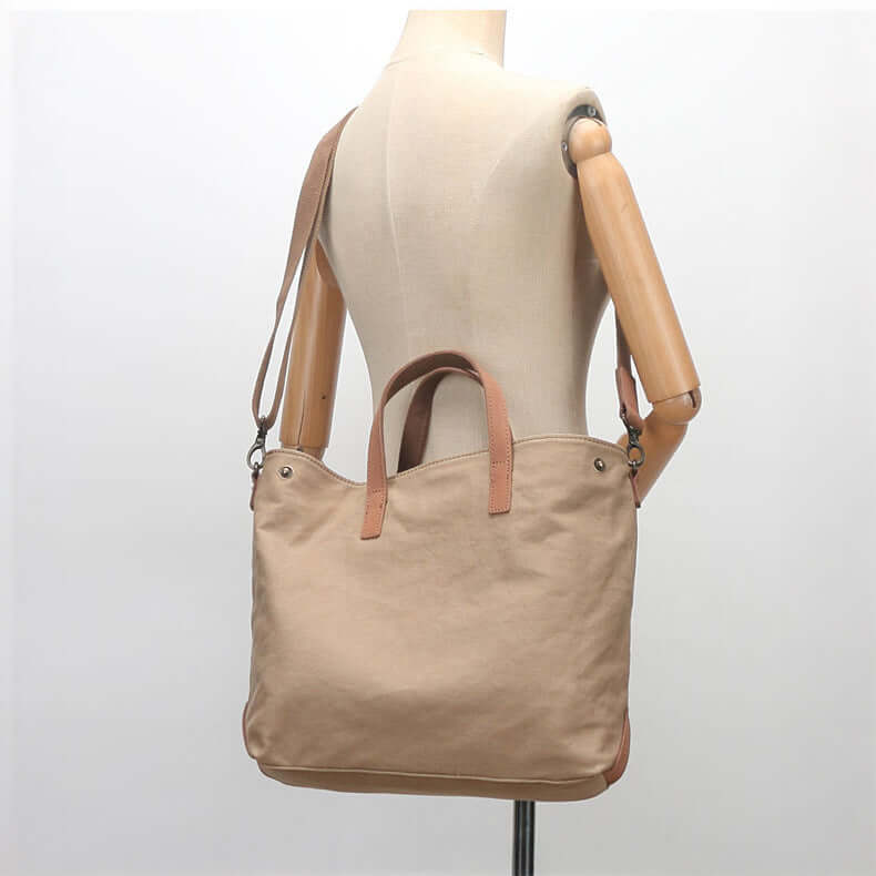 Khaki canvas tote bag worn over shoulder.