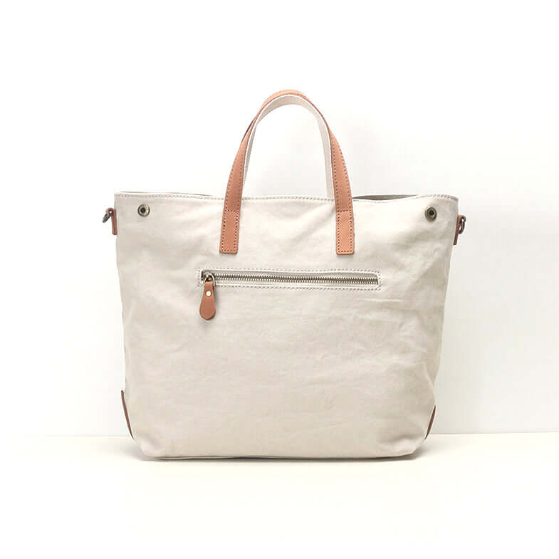 Back zipper pocket of white canvas tote bag.