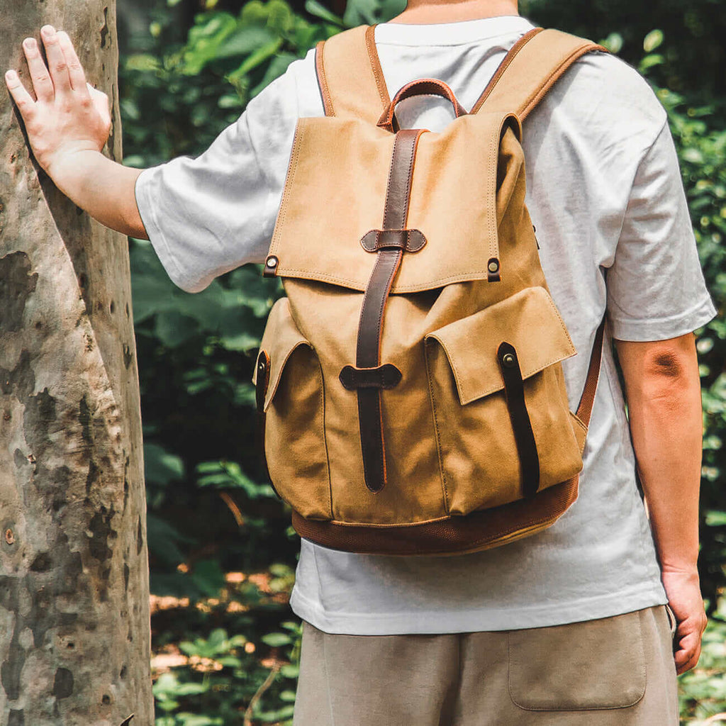 Casual brown canvas backpack for men, featuring a vintage design with leather accents.