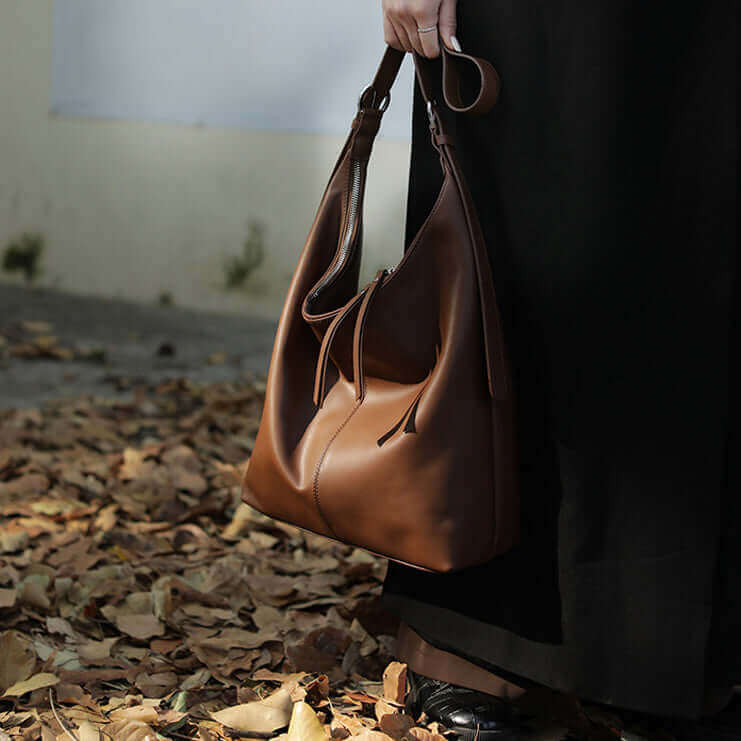 Lifestyle image of a leather shoulder bag used in casual outings.