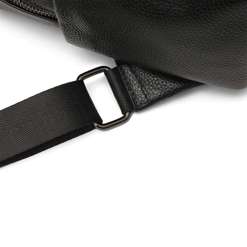 Close-up of a black leather backpack with a strap