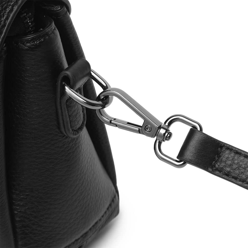 Close-up of a black leather bag with a metal clasp