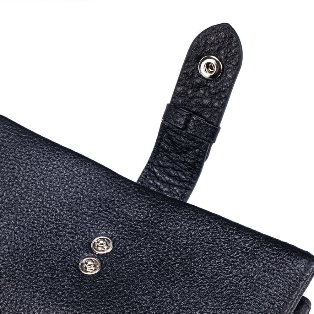 Close-up of a black leather wallet with a strap