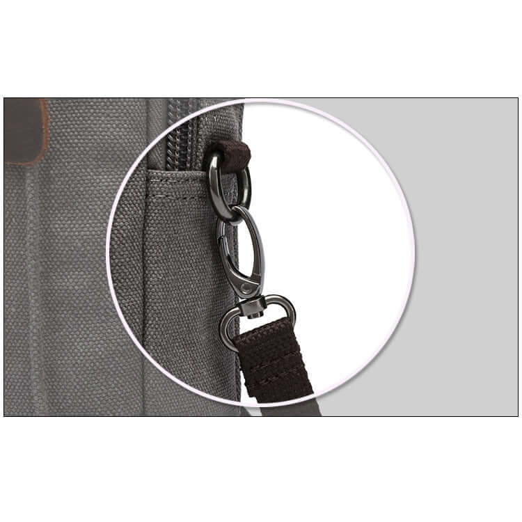 Close-up of a grey bag with a metal clasp and strap detail.