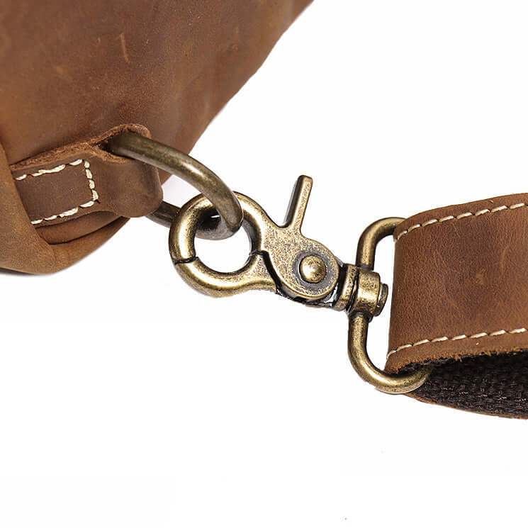 Close-up of a brown leather bag with a brass clasp