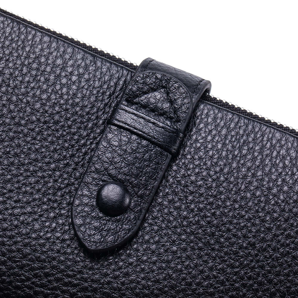 Close-up of a black leather long wallet with a clasp