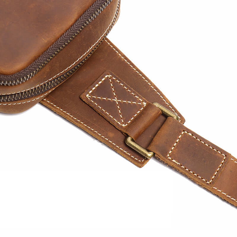 Close-up of a brown leather bag with buckle 