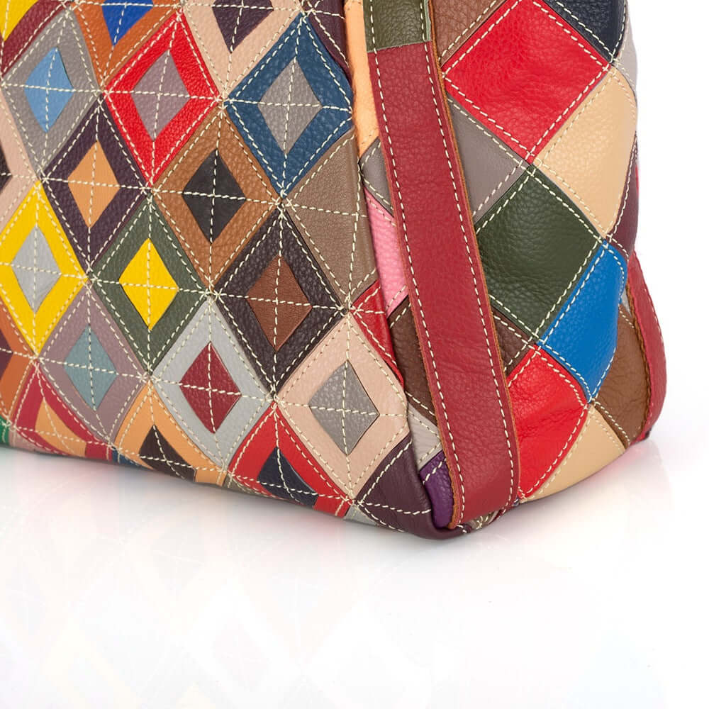 Close-up of the colorful patchwork detailing on the leather tote bag.