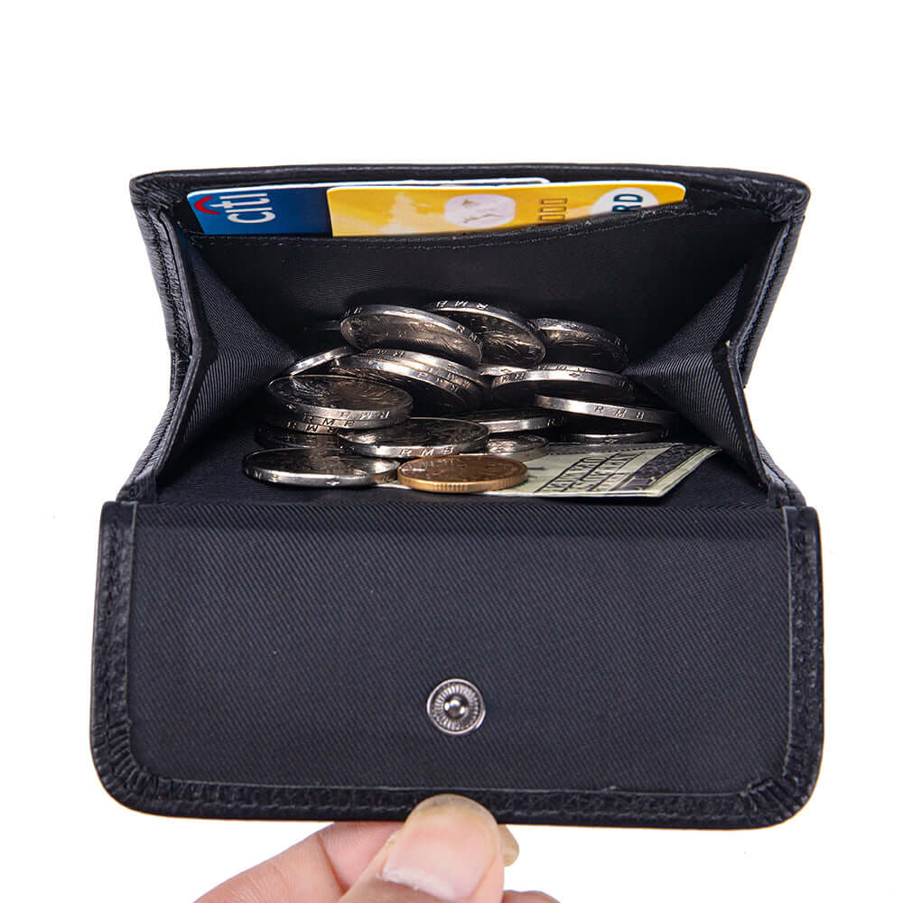 Black wallet with coins and cards held by a hand